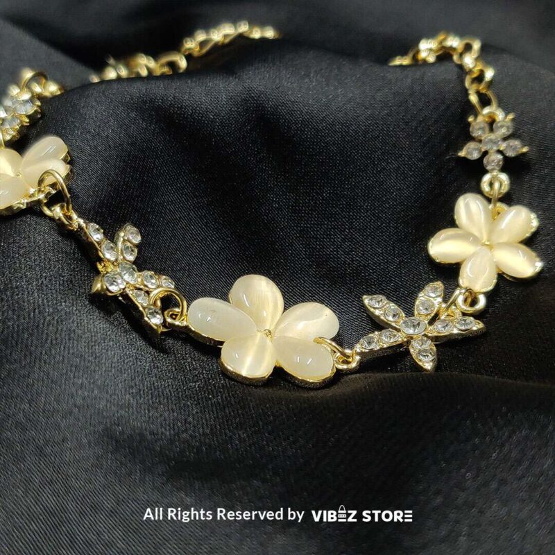 Ivory Floral Charm Bracelet with delicate crystals set on a golden chain from VibezStore