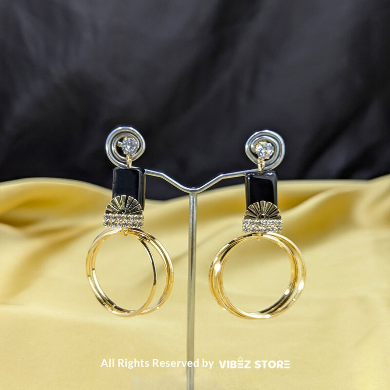 Black and gold hoop earrings with sparkling accents and a fan-inspired design, displayed elegantly by Vibez Store.