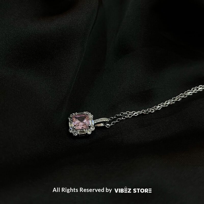 Square Pink Gemstone Locket with silver-tone chain on a black background