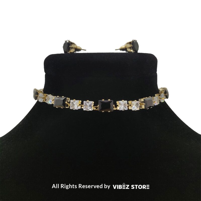 Square-stone choker necklace with matching earrings on display, featuring alternating black and clear stones