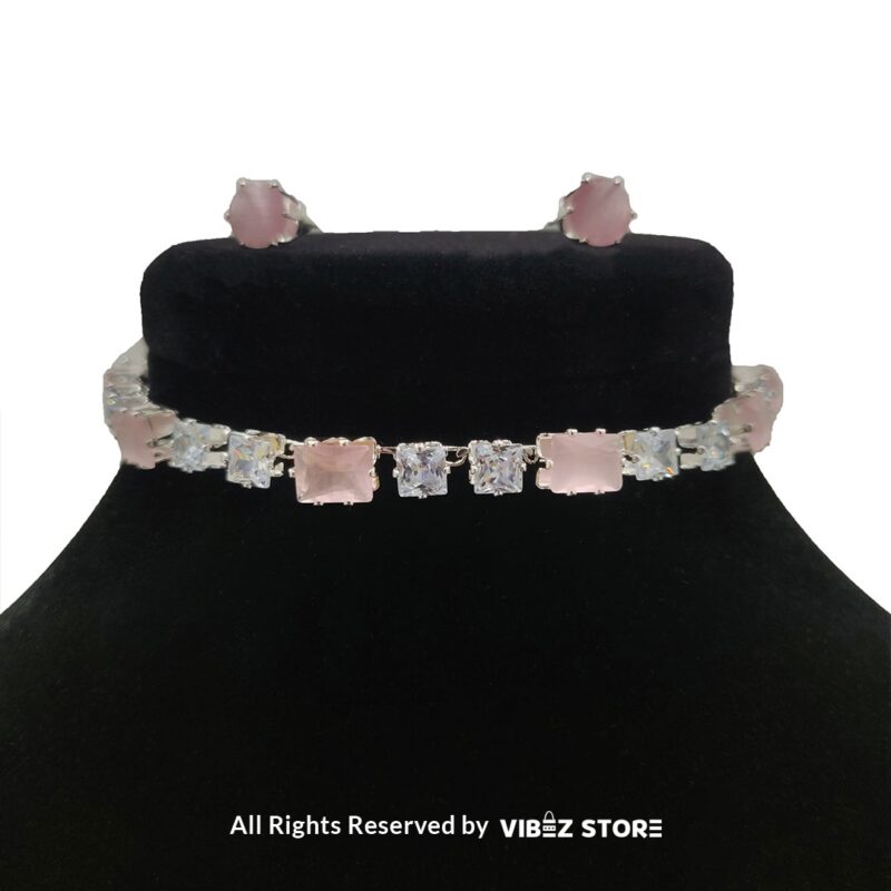 Square-stone choker necklace with matching earrings on display, featuring alternating black and clear stones