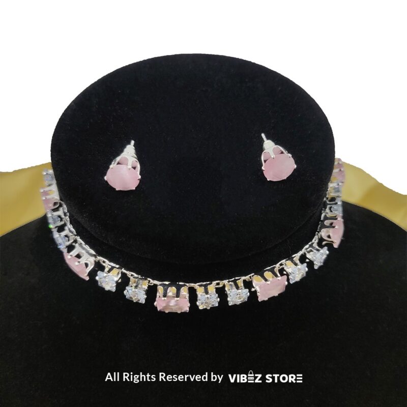 Square-stone choker necklace with matching earrings on display, featuring alternating black and clear stones