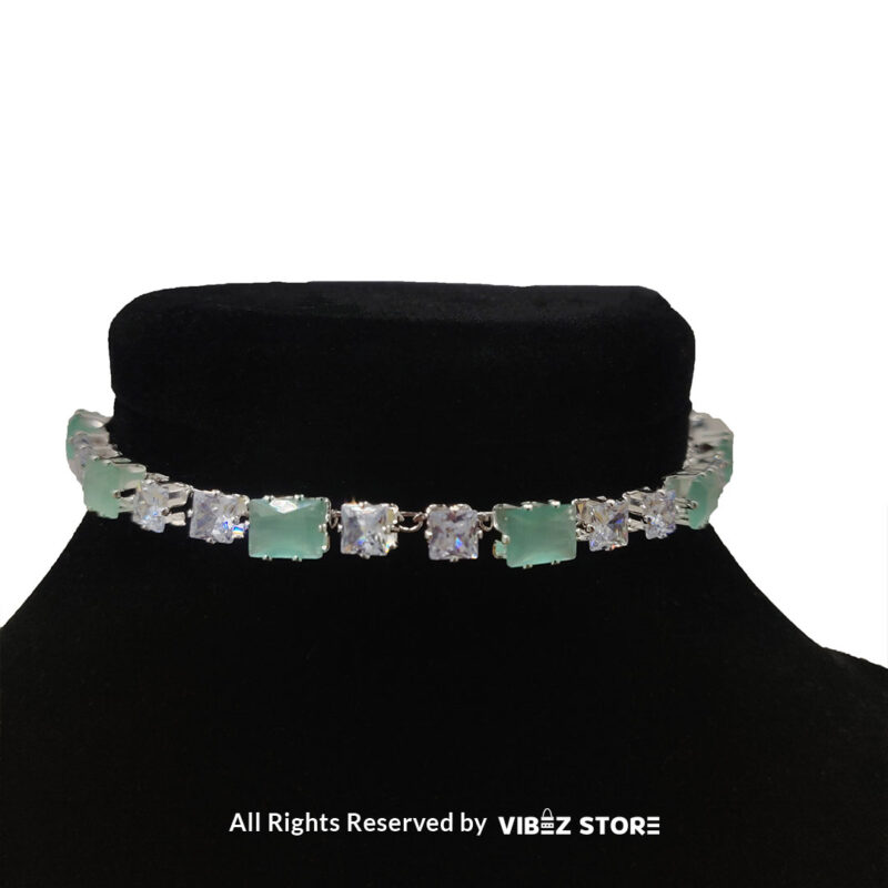 Square-stone choker necklace with matching earrings on display, featuring alternating black and clear stones