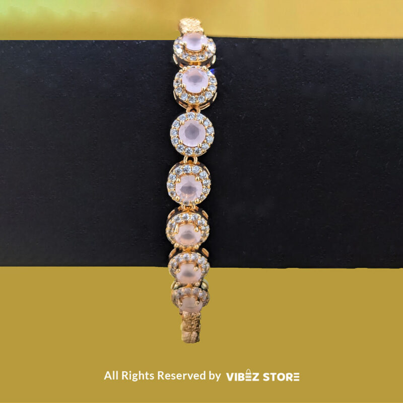 Gold-tone jewelry set with rose quartz-inspired stones, including a necklace, earrings, bracelet, and ring, elegantly displayed by Vibez Store.