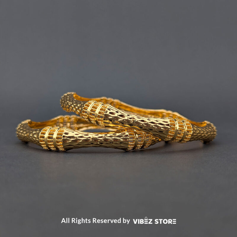 Pair of gold-tone twisted bangles with a textured finish, displayed elegantly by Vibez Store.