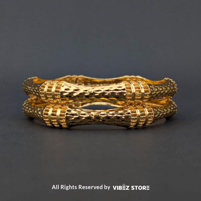 Pair of gold-tone twisted bangles with a textured finish, displayed elegantly by Vibez Store.