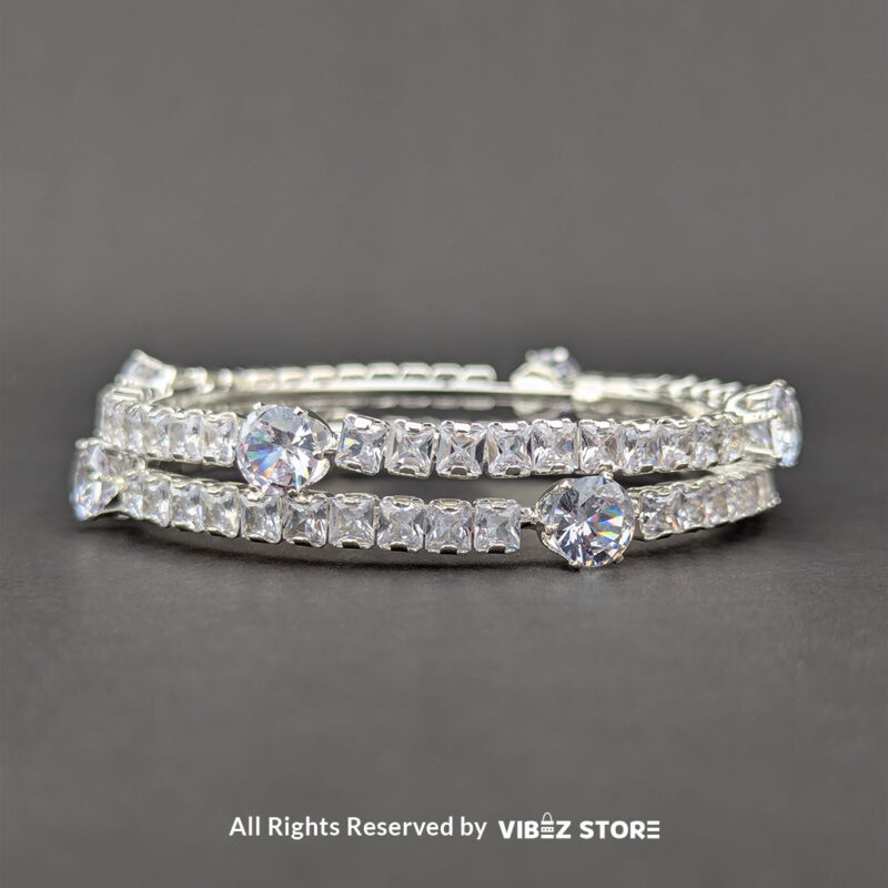 Elegant silver bangles with sparkling round and square-cut crystals on a sleek design.