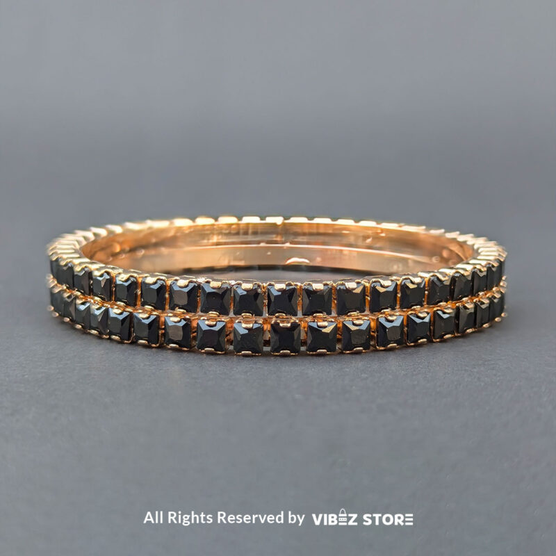 Rose gold bangles set with black crystals for party wear.