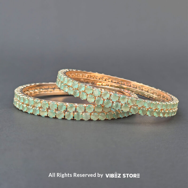 Sea green crystal bangles set on gold-tone base for festive wear.