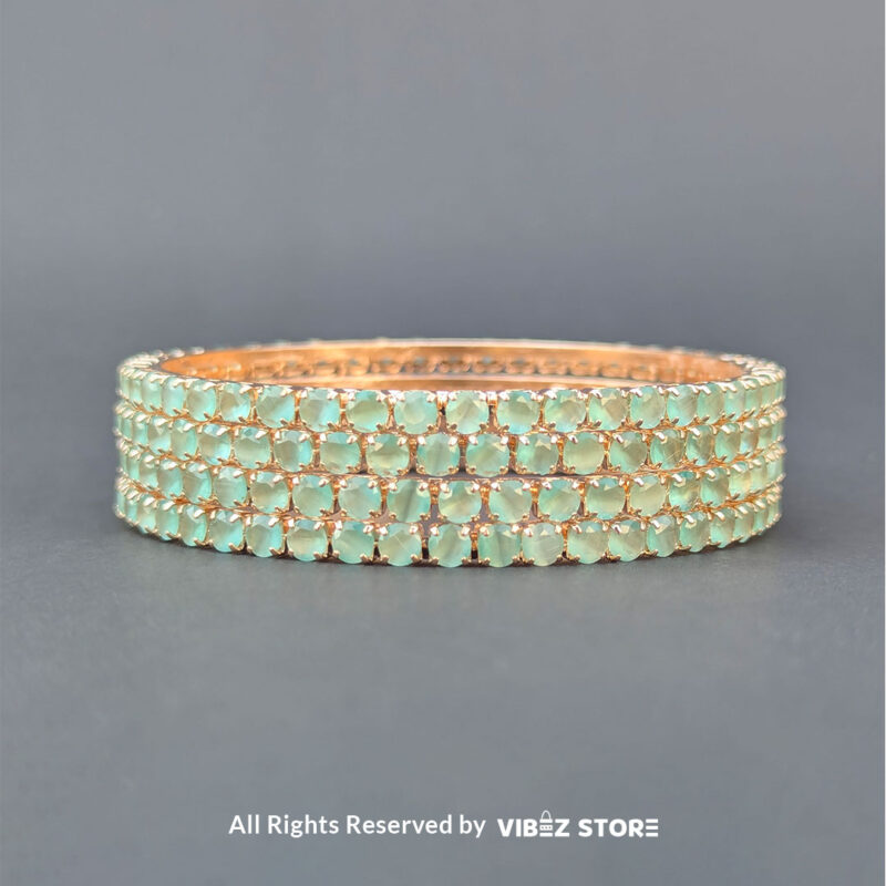 Sea green crystal bangles set on gold-tone base for festive wear.