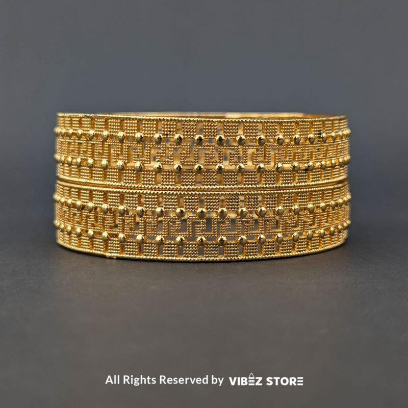 Artificial gold bangle with textured design, displayed elegantly by Vibez Store