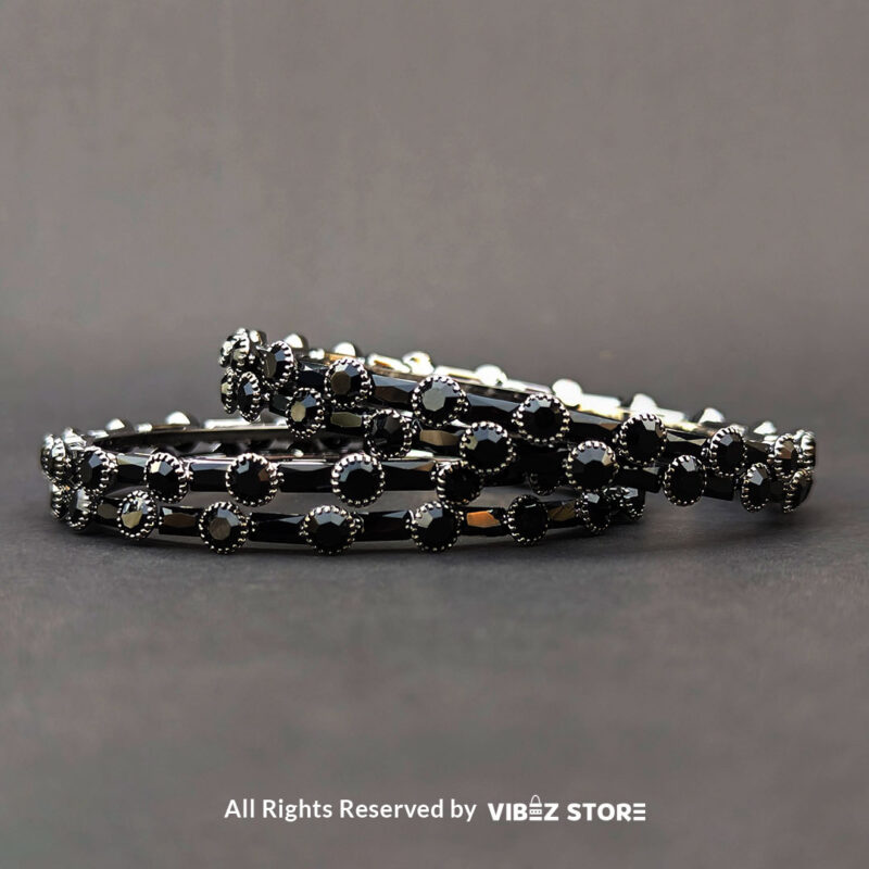 Black stone bangle with circular stone pattern, displayed elegantly by Vibez Store