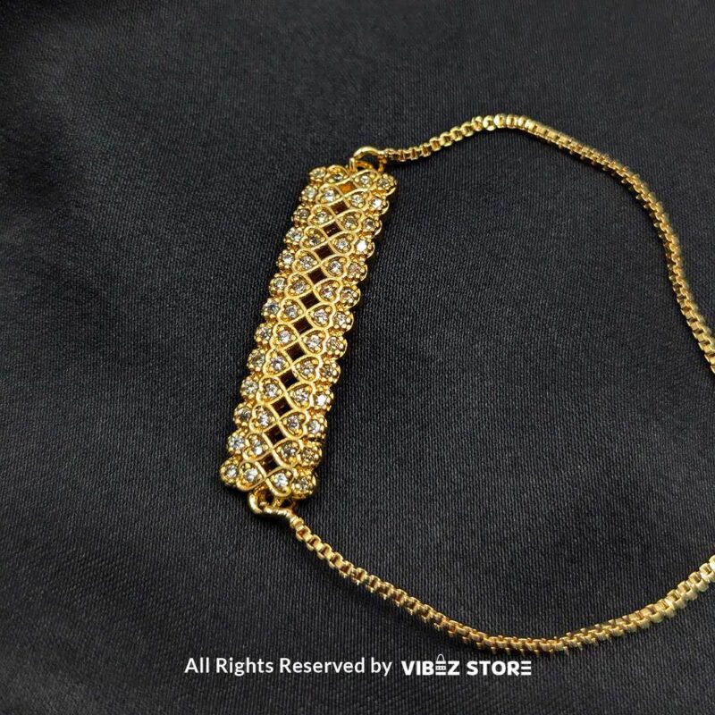 Gold-tone adjustable bracelet with crystal mesh design on a black background