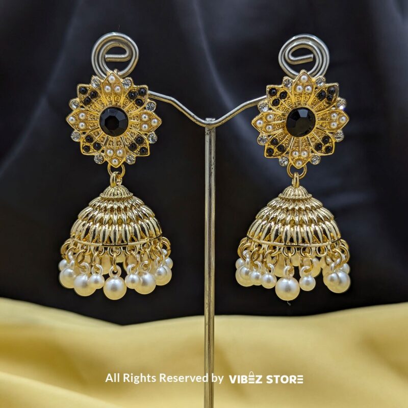 Gold-tone jhumka earrings with floral motifs, pearl drops, and a secure push-back closure, displayed with intricate detailing and a traditional design.