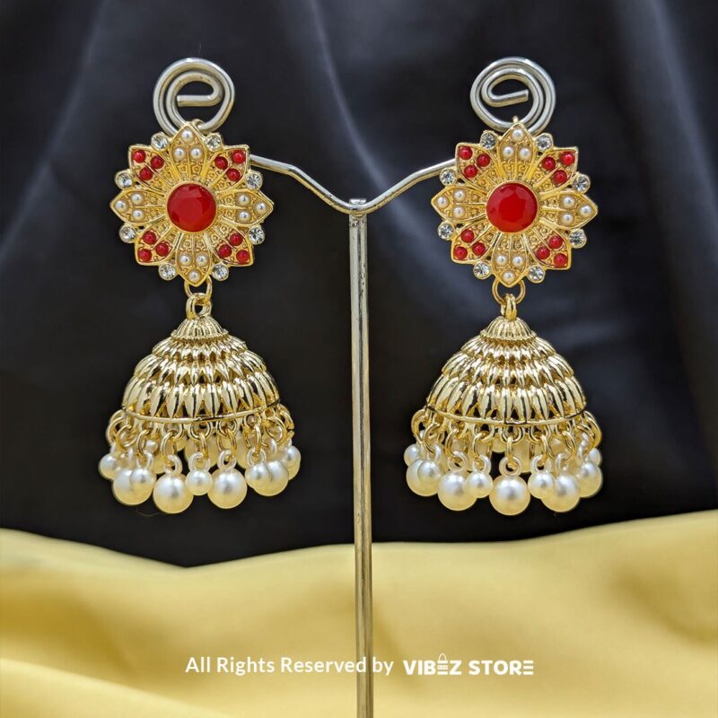 Gold-tone jhumka earrings with floral motifs, pearl drops, and a secure push-back closure, displayed with intricate detailing and a traditional design.