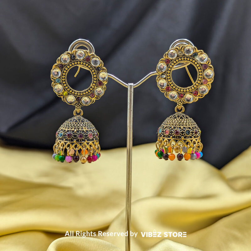 Traditional round gold-tone jhumka earrings with mirrored accents and colorful bead detailing.