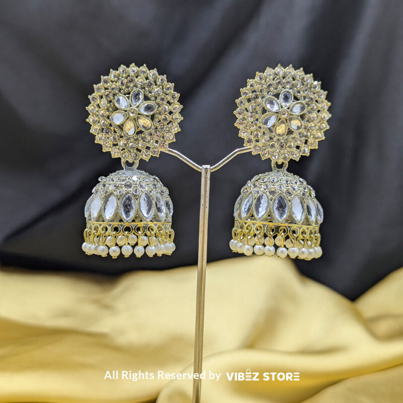 Crystal kundan dome jhumka earrings with intricate detailing and pearl drop accents.