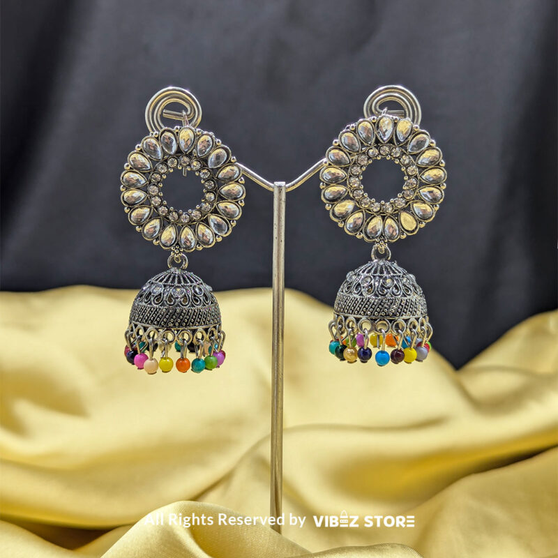 Silver-plated kundan jhumka earrings with circular design and vibrant multicolor bead accents, perfect for festive and cultural occasions.