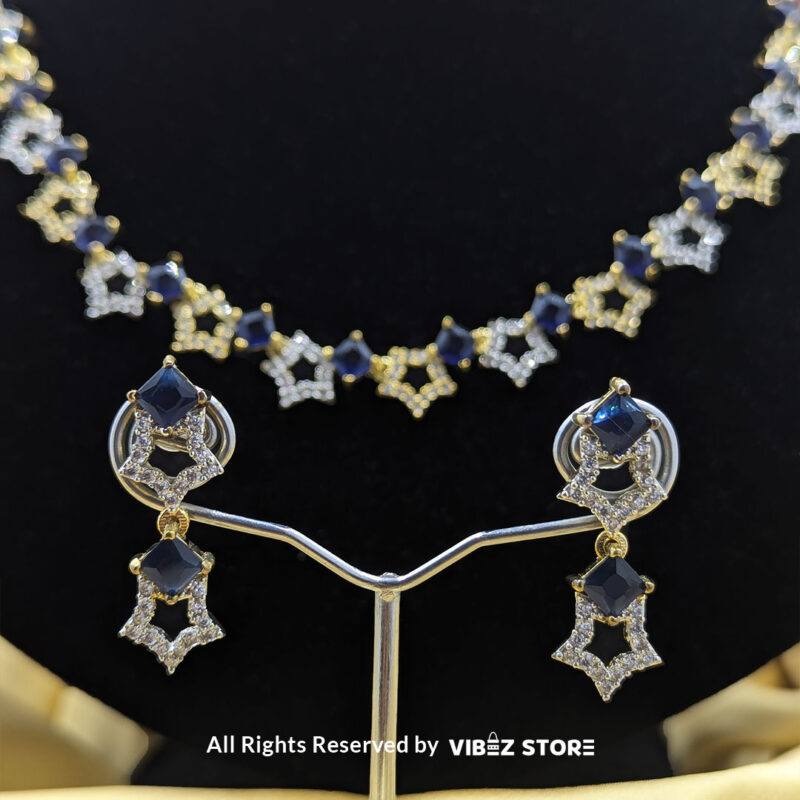 Midnight Sapphire Star Necklace and Earring Set with gold-tone star designs, faux sapphire stones, and crystal accents from VibezStore