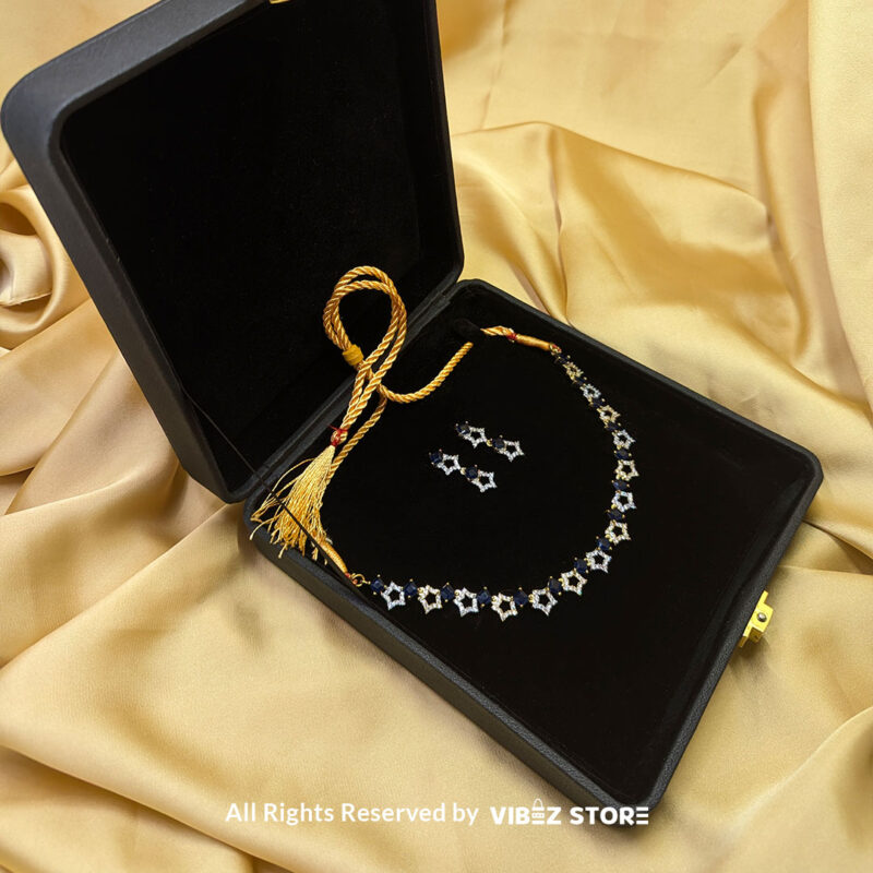 Midnight Sapphire Star Necklace 3 Midnight Sapphire Star Necklace and Earring Set with gold-tone star designs, faux sapphire stones, and crystal accents from VibezStore