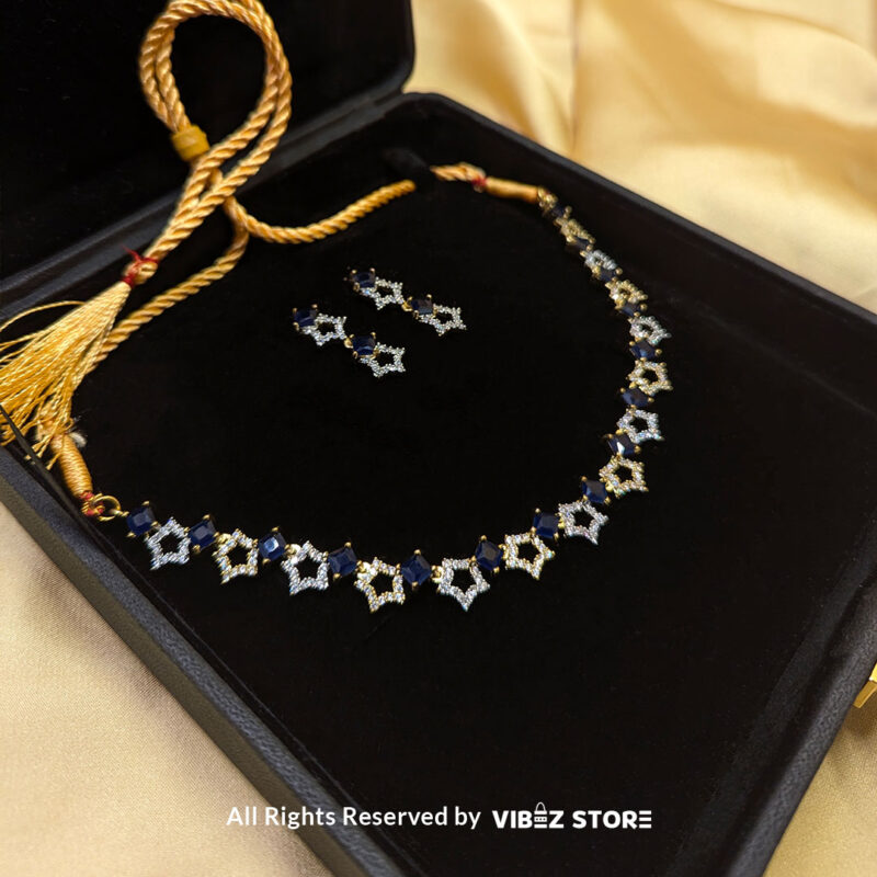 Midnight Sapphire Star Necklace 2 Midnight Sapphire Star Necklace and Earring Set with gold-tone star designs, faux sapphire stones, and crystal accents from VibezStore