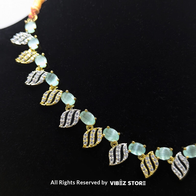 Mint Green Leaf Necklace and Earring Set with gold-tone settings, mint green gemstones, and leaf-shaped crystal designs from VibezStore