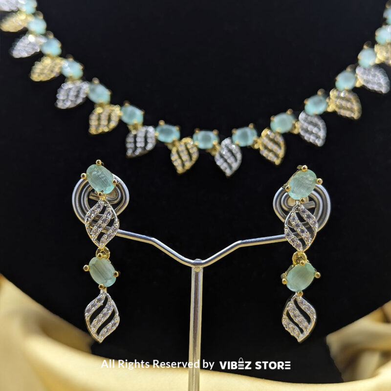 Mint Green Leaf Necklace and Earring Set with gold-tone settings, mint green gemstones, and leaf-shaped crystal designs from VibezStore