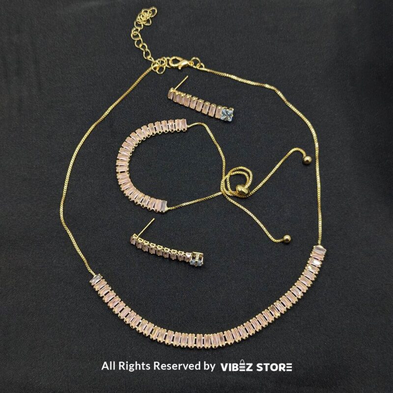 Pink crystal jewelry set featuring a necklace, bracelet, ring, and earrings with baguette-style crystals.