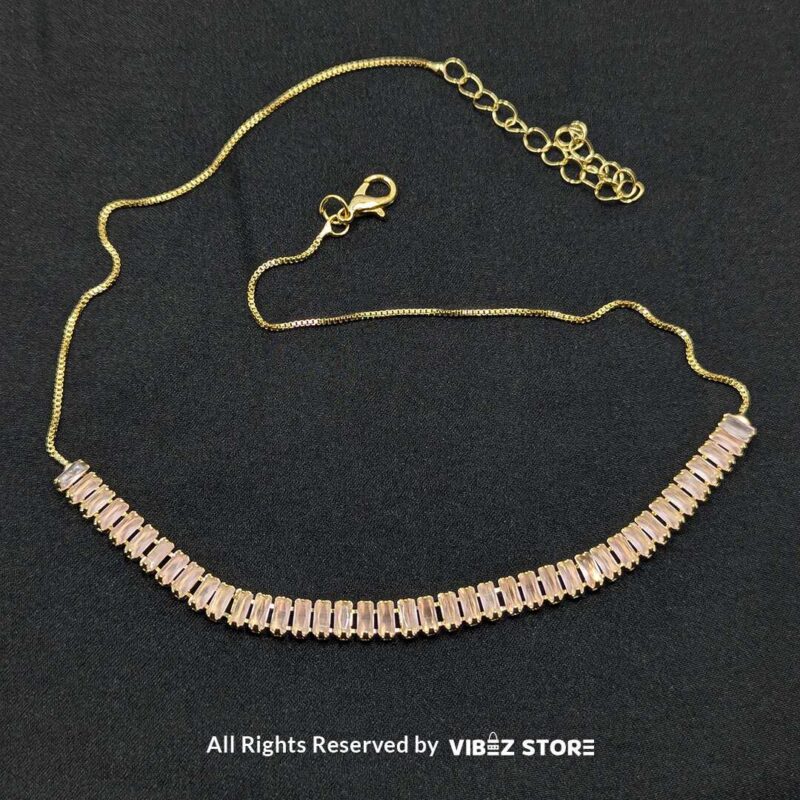 Pink crystal jewelry set featuring a necklace, bracelet, ring, and earrings with baguette-style crystals.