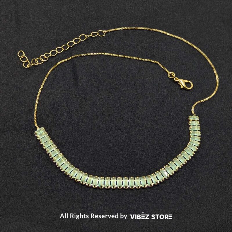 Mint green crystal jewelry set with a necklace, bracelet, ring, and earrings featuring baguette-style crystals.