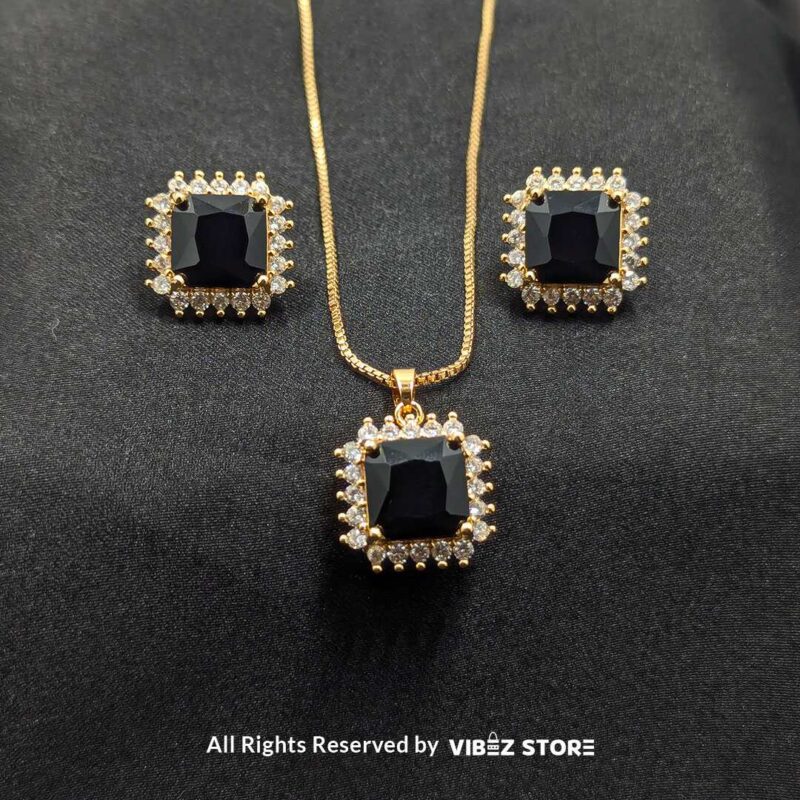 Black square pendant jewelry set featuring a necklace with a gold chain and matching stud earrings adorned with cubic zirconia.