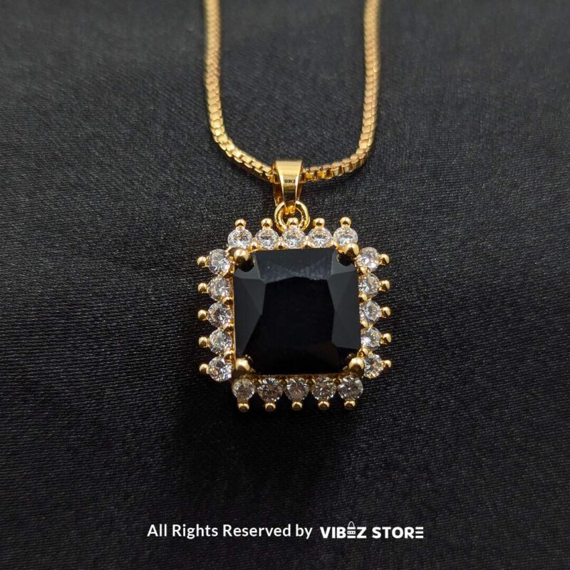 Black square pendant jewelry set featuring a necklace with a gold chain and matching stud earrings adorned with cubic zirconia.