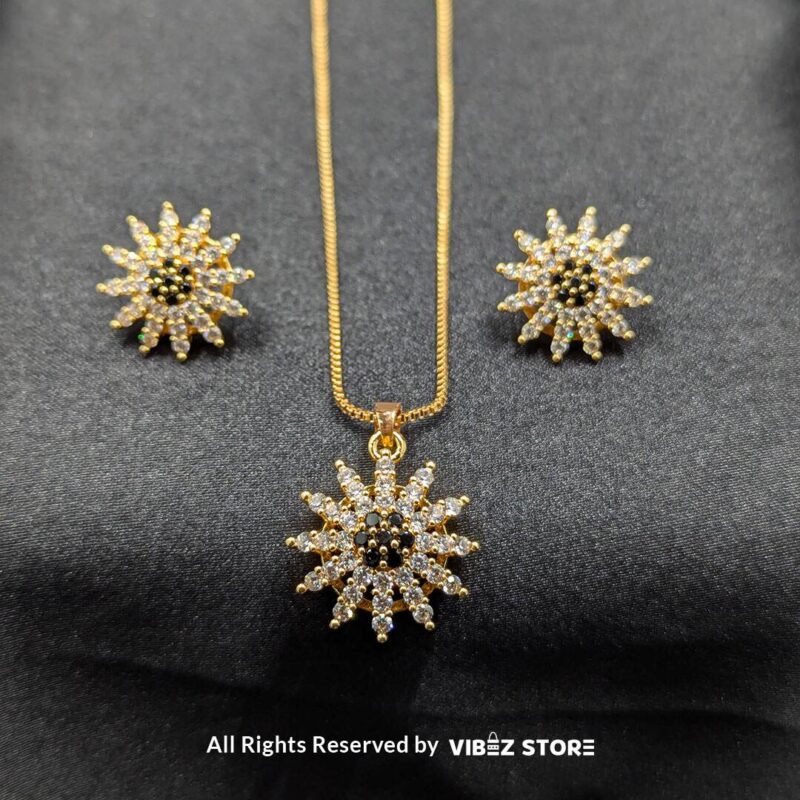 Radiant sunflower-inspired pendant and matching earrings set, crafted with sparkling crystals on a sleek black backdrop.