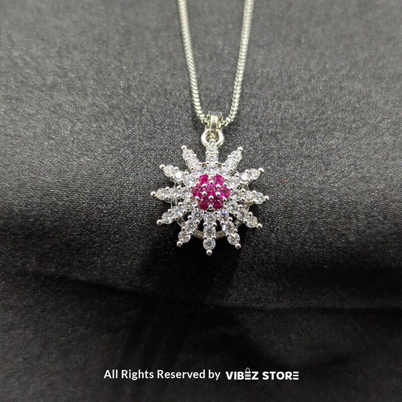 Ruby sunflower jewelry set with a sparkling pendant and earrings featuring ruby-colored accents on a sleek black backdrop.