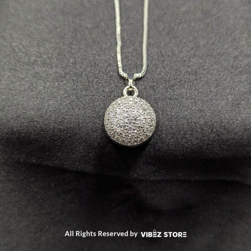 Sphere-shaped pendant and earrings set featuring shimmering crystals, displayed on a sleek black backdrop. Available in multiple color variations.