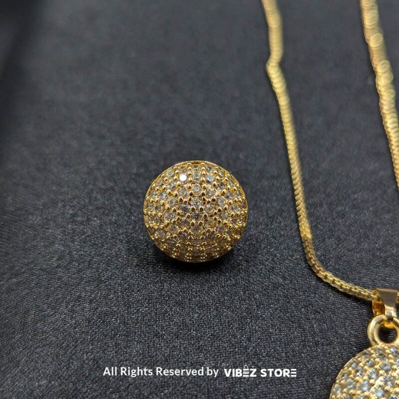 Sphere-shaped pendant and earrings set featuring shimmering crystals, displayed on a sleek black backdrop. Available in multiple color variations.