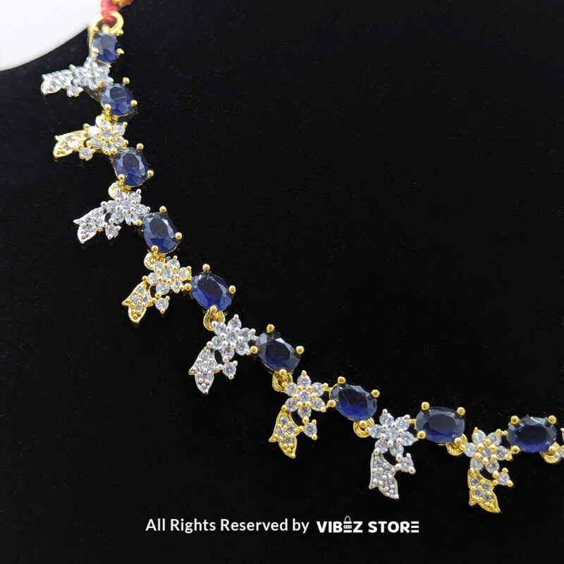 Sapphire Floral Necklace and Earring Set with gold-tone settings, faux sapphire stones, and crystal floral designs from VibezStore