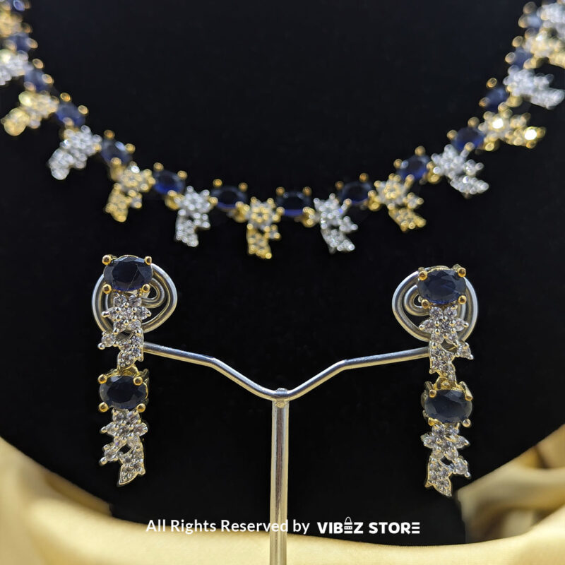 Sapphire Floral Necklace and Earring Set with gold-tone settings, faux sapphire stones, and crystal floral designs from VibezStore