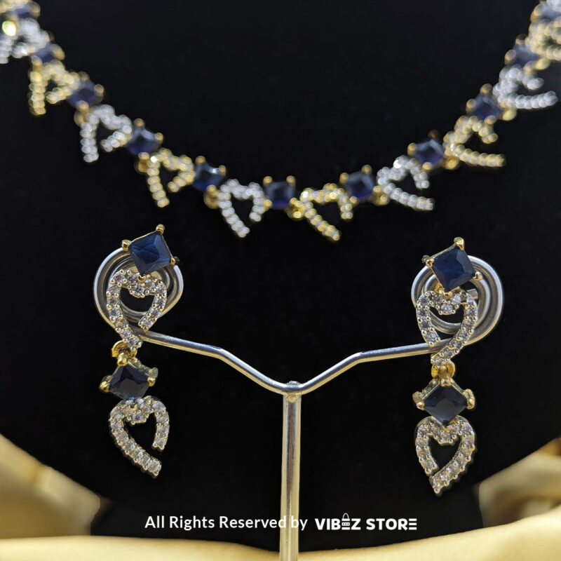 Heart & Sapphire Necklace and Earring Set with gold-tone settings, faux sapphire stones, and crystal heart motifs from VibezStore