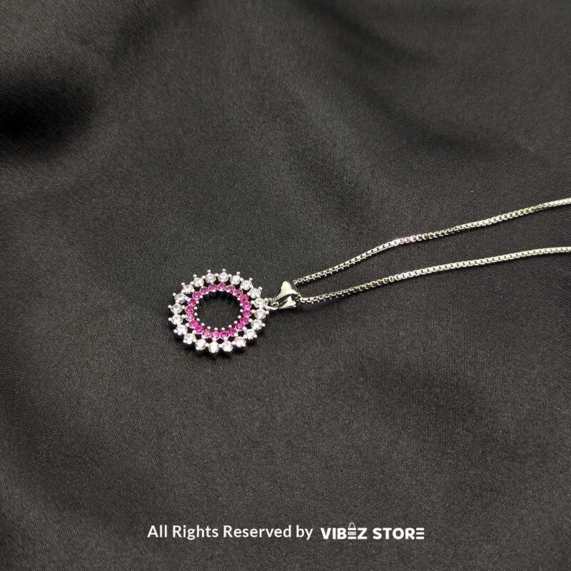 Three round cluster crystal lockets in gold, silver, and silver-pink designs displayed elegantly on a black fabric background.