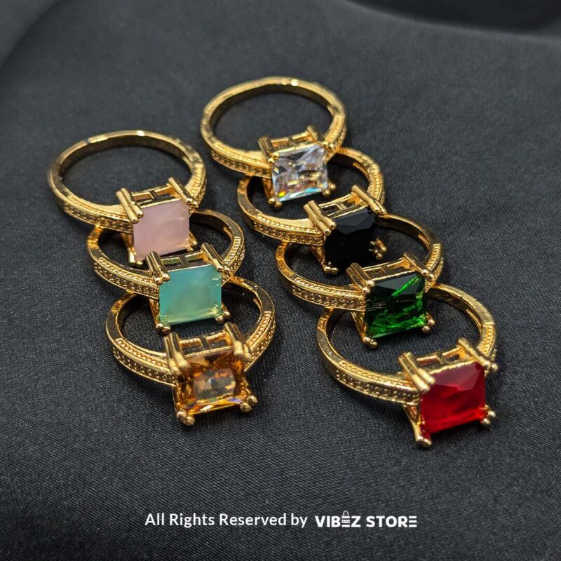 Gold-tone non-adjustable rings with square gemstones in multiple colors, including rose pink, aqua blue, emerald green, ruby red, black, crystal white, and amber gold, beautifully displayed by Vibez Store.