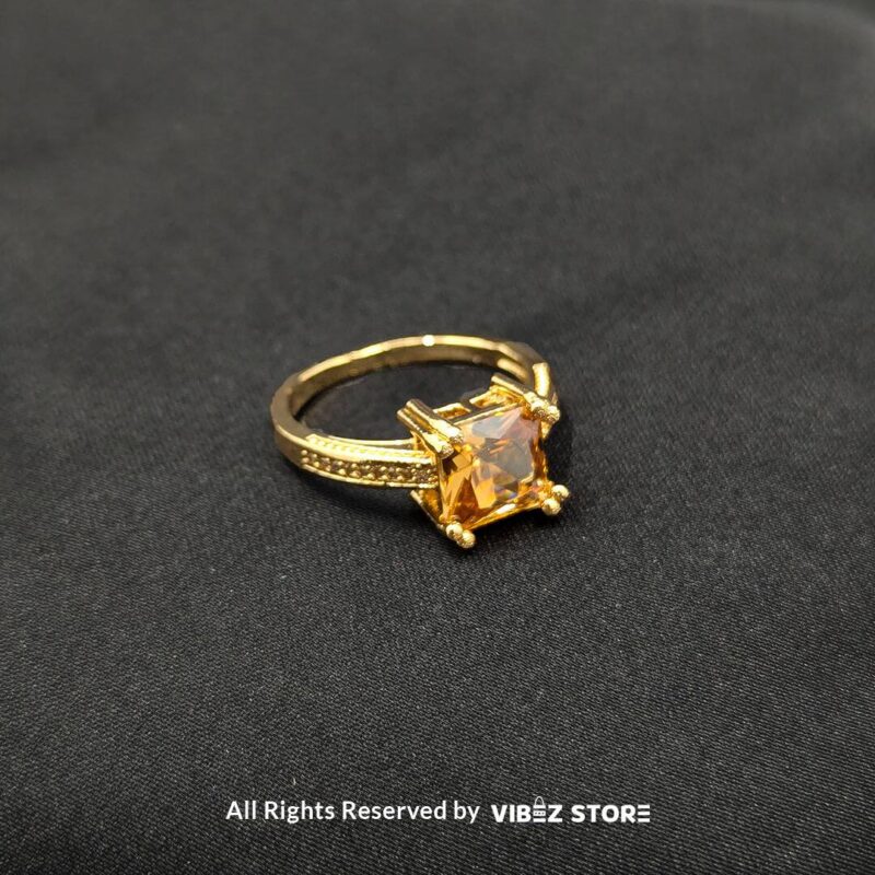 Gold-tone non-adjustable rings with square gemstones in multiple colors, including rose pink, aqua blue, emerald green, ruby red, black, crystal white, and amber gold, beautifully displayed by Vibez Store.