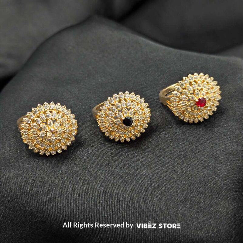 Gold-tone floral rings with crystal accents and central gemstones in jet black, ruby red, and champagne gold, beautifully displayed by Vibez Store.