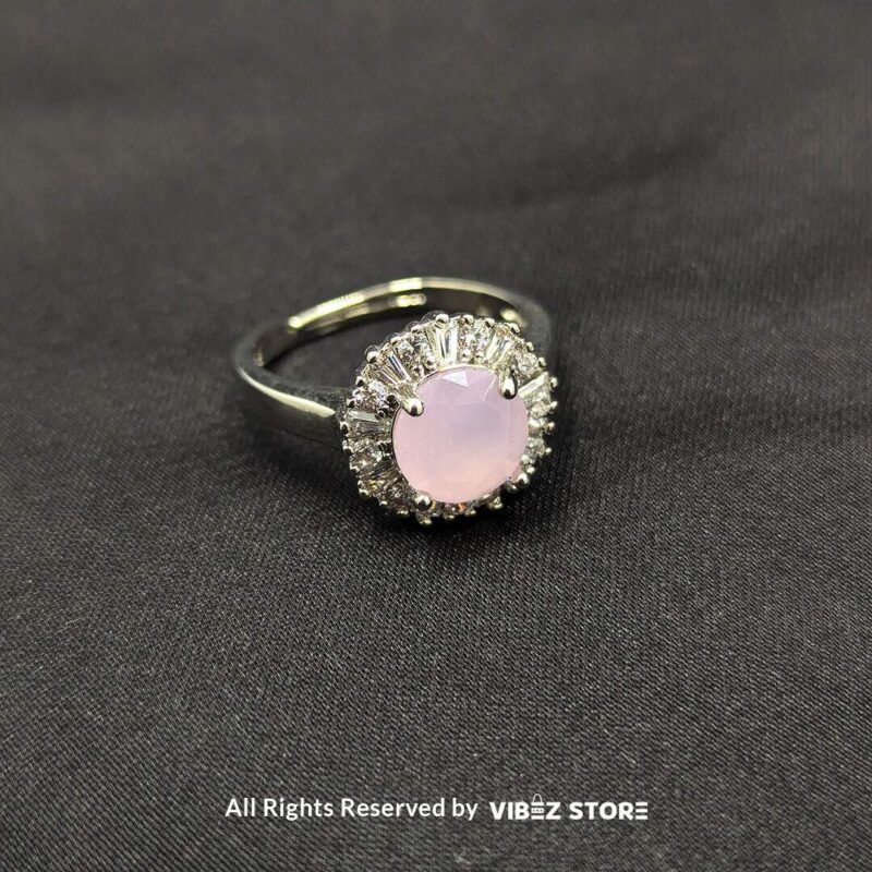 Silver-tone halo rings with radiant gemstones in emerald green, rose pink, and aquamarine blue, encircled by sparkling crystals, showcased by Vibez Store.