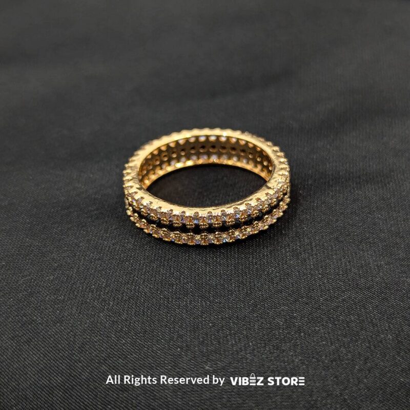 Gold-tone eternity band with dual rows of sparkling crystals, perfect for elegant and timeless fashion, from Vibez Store.