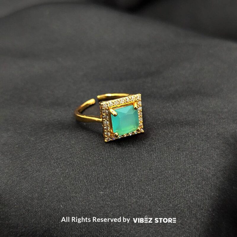 Gold-tone adjustable rings with square gemstones in rose pink, aqua blue, and sapphire variations, elegantly displayed by Vibez Store.