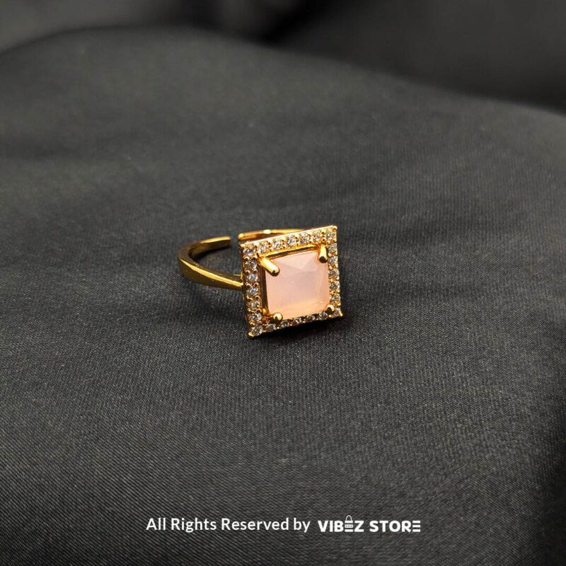 Gold-tone adjustable rings with square gemstones in rose pink, aqua blue, and sapphire variations, elegantly displayed by Vibez Store.