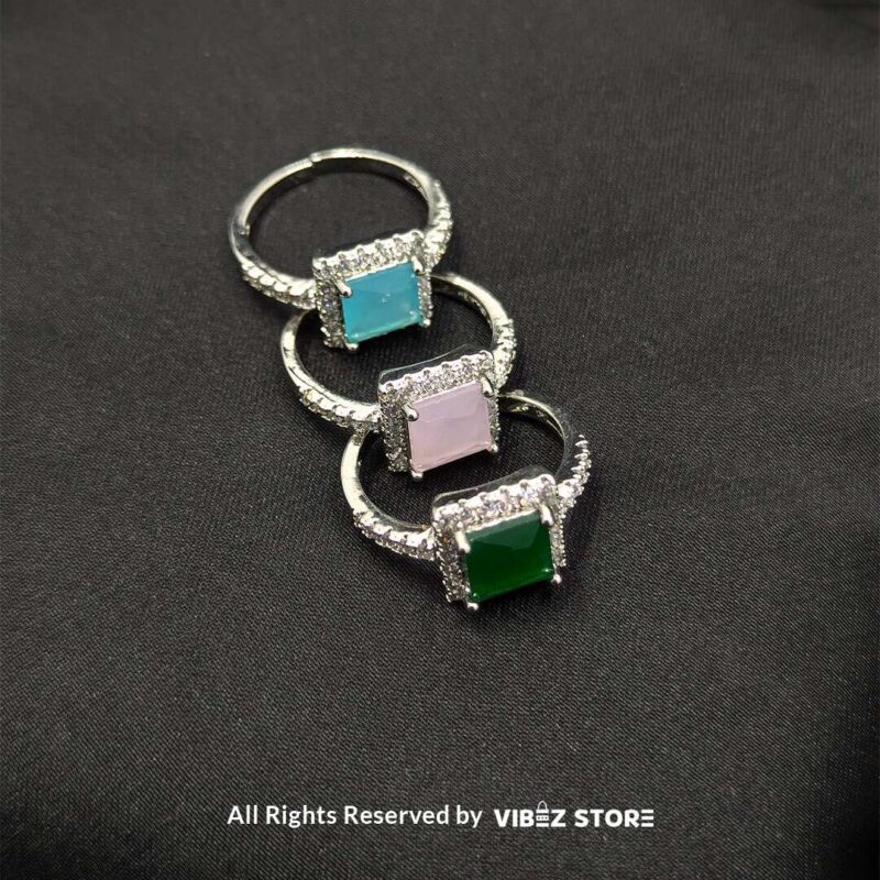 Silver-tone adjustable rings with square gemstones in aqua blue, rose pink, and emerald green, elegantly displayed by Vibez Store.