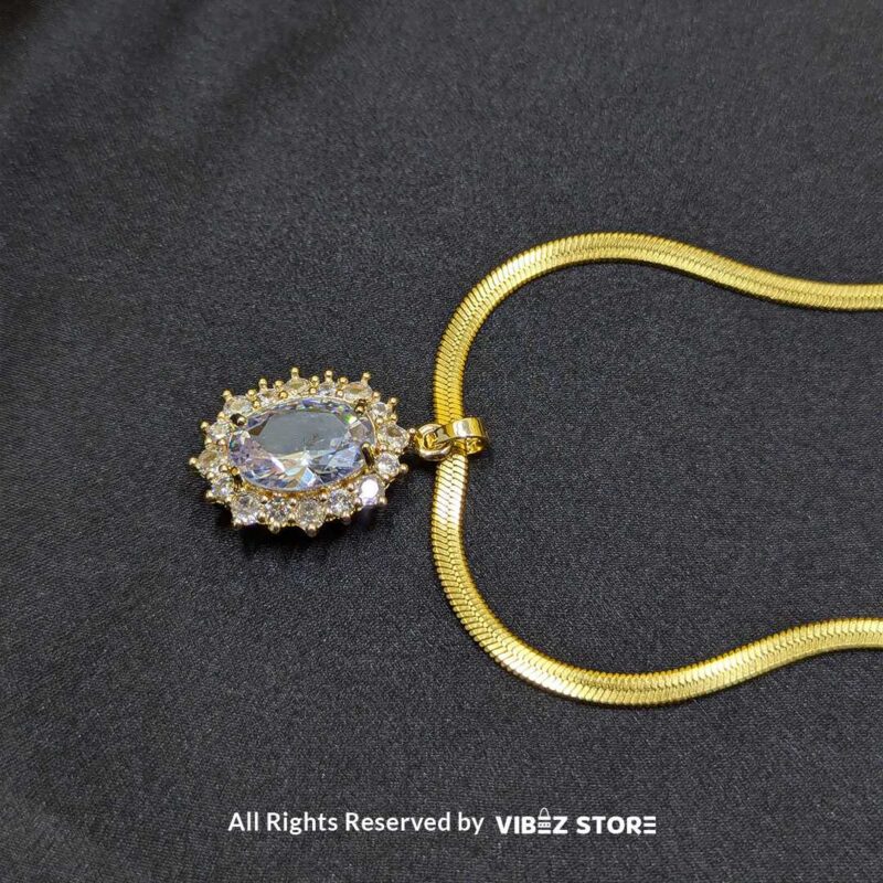 Gold Oval Pendant Necklace with Radiant Crystal 1 Gold Oval Pendant Necklace with a radiant crystal centerpiece and a sleek gold-tone chain – Vibez Store.