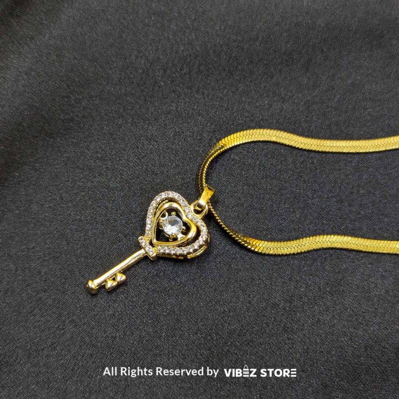 Gold Heart Key Pendant Necklace 1 Gold Heart Key Pendant Necklace with a sparkling crystal centerpiece on a sleek gold chain – Vibez Store.